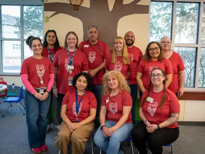 Kyle Public Library staff stand together for a posed photo to celebrate their recent 2025 Achievement of Excellence in Libraries Award from the Texas Municipal Library Directors Association.