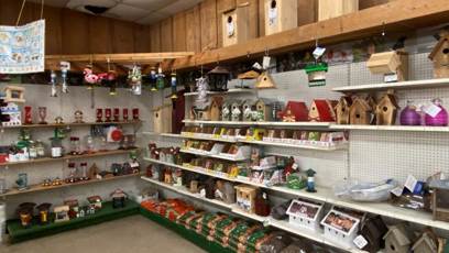 Shelves with bird houses and bird feeders

AI-generated content may be incorrect.