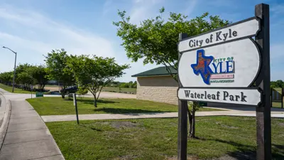 city of kyle waterleaf park wooden sign in front of park