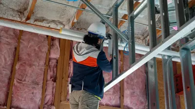 A construction worker works inside the Kyle Community Center located at 1550 Dacy Lane. 